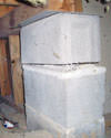 Concrete crawl space support posts in Fresh Meadows that are showing signs of failure as they sink into the earth.