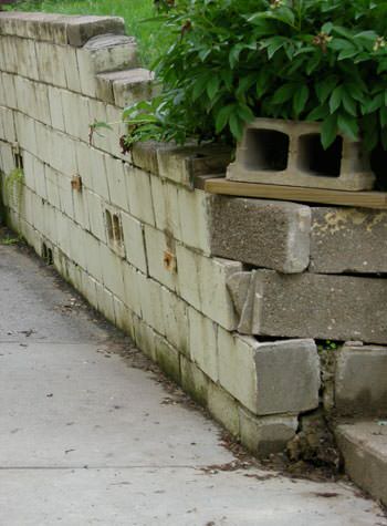 collapsing retaining wall with severe damage in Woodhaven