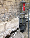 A completed installation of foundation push piers lifting a foundation in Far Rockaway