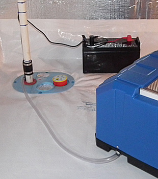 Closeup of a crawl space sump pump installed in Queens