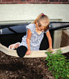 A child crawling out of an egress entryway window system in Astoria.