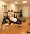 a basement gym and workout room with a wood laminate flooring, installed in Staten Island, NY