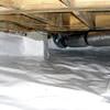 Bare floor joists in a sealed, insulated crawl space in Flushing.