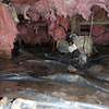 Fiberglass insulation dripping off some heating ducts in a wet crawl space in Howard Beach.