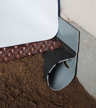 Closeup of a crawl space drainage system installed in Middle Village