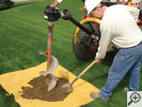 Auguring a hole in the earth for a foundation repair in Forest Hills