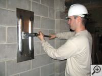 Attempting to straighten a bowed foundation wall by straightening a wall anchor system in a Elmhurst home.