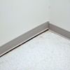 A partition wall separating from the floor in a Rego Park home.
