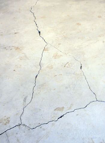 severely cracked, heaving slab floors in a home in Maspeth