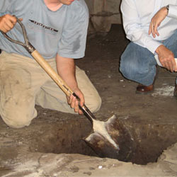 Digging a hole for the engineered fill used in a crawl space support system installation in Astoria