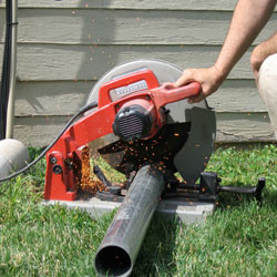 Cutting the support beam for a crawl space jack post outside a Elmhurst home.