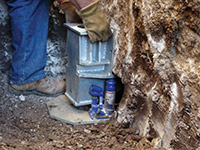 Securing a foundation footing bracket for a foundation repair system in Jackson Heights.