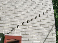 Stair-step cracks showing in a home foundation in Saint Albans