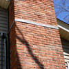 A tilting chimney on a Long Island City home with a leaning, tilting chimney that was temporarily repaired.