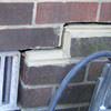A closeup of a failed tuckpointing job where the brick cracked on a Rockaway Park home.