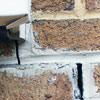Failed crack repair showing old tuckpointing that cracked on a Bronx home.