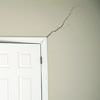 A long drywall crack beginning at the corner of a doorway in a Rego Park home.