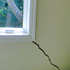 A long, diagonal crack that begins at a window corner of a South Richmond Hills home