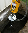 Installing a helical pier during a foundation repair in Manhattan