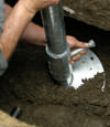Manhattan helical pier installation nearing completion, with the blade being advanced into the foundation soils.