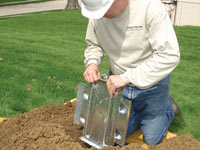 Fastening an earth anchor for a severely bowing wall in Queens.