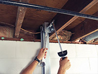 Straightening a foundation wall with the PowerBrace™ i-beam system in a Ridgewood home.