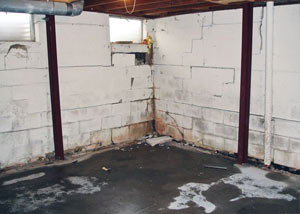 A failed, rusty i-beam foundation wall system installed in Middle Village.