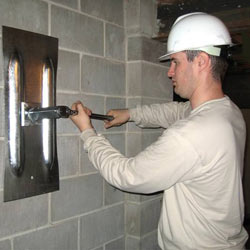 installing a wall anchor to repair an bowing foundation wall in Ridgewood