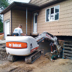 Excavating to expose the foundation walls and footings for a replacement job in Woodside