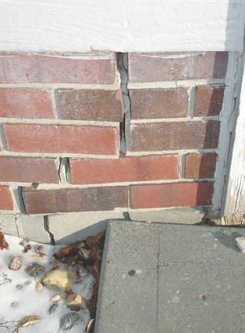 Severe street creep damage to a garage wall outside a Howard Beach home