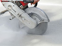 Cutting the driveway for expansion joints during street creep repair in Far Rockaway