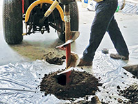 Digging the hole used for wall anchor installation in Whitestone.