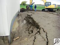 A foundation wall showing severe damage from bowing and buckling in Far Rockaway