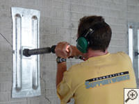 Mounting the steel wall plate for foundation wall repair and straightening in Whitestone.