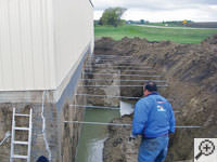 Drilling the hole in the foundation wall for street creep repairs in Saint Albans