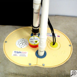 A sump pump system installed along a basement floor in Brooklyn.