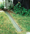 A recessed gutter drain extension installed in Sunnyside, New York