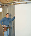 Installing wall panels on top of our basement wall insulation in Astoria