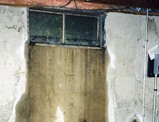 Water pouring out from a basement window in Staten Island
